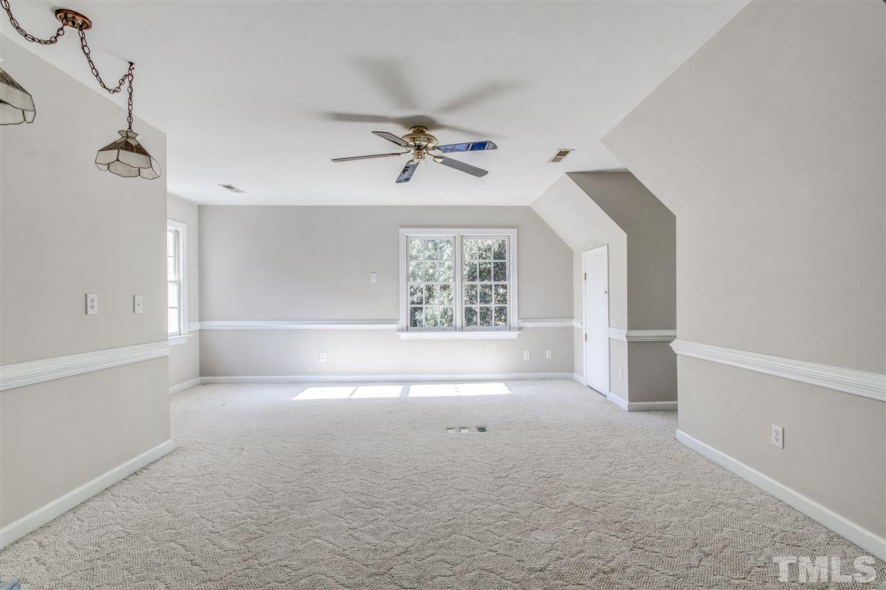 9024 Hemingwood Court Raleigh, NC 27613 - Photo 23 of 28 wooden floor in an empty room with a window