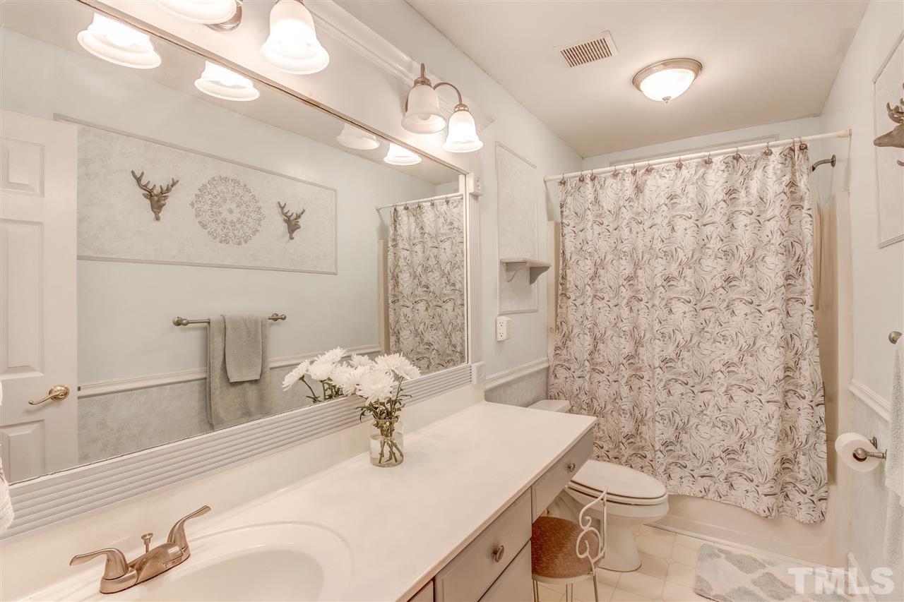 9024 Hemingwood Court Raleigh, NC 27613 - Photo 24 of 28 a bathroom with a sink toilet and shower