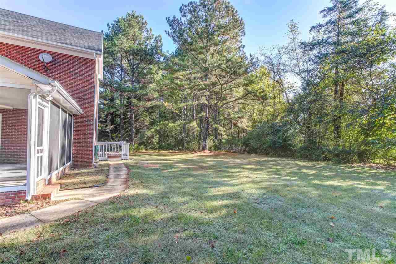 9024 Hemingwood Court Raleigh, NC 27613 - Photo 27 of 28 a view of a house with backyard and trees