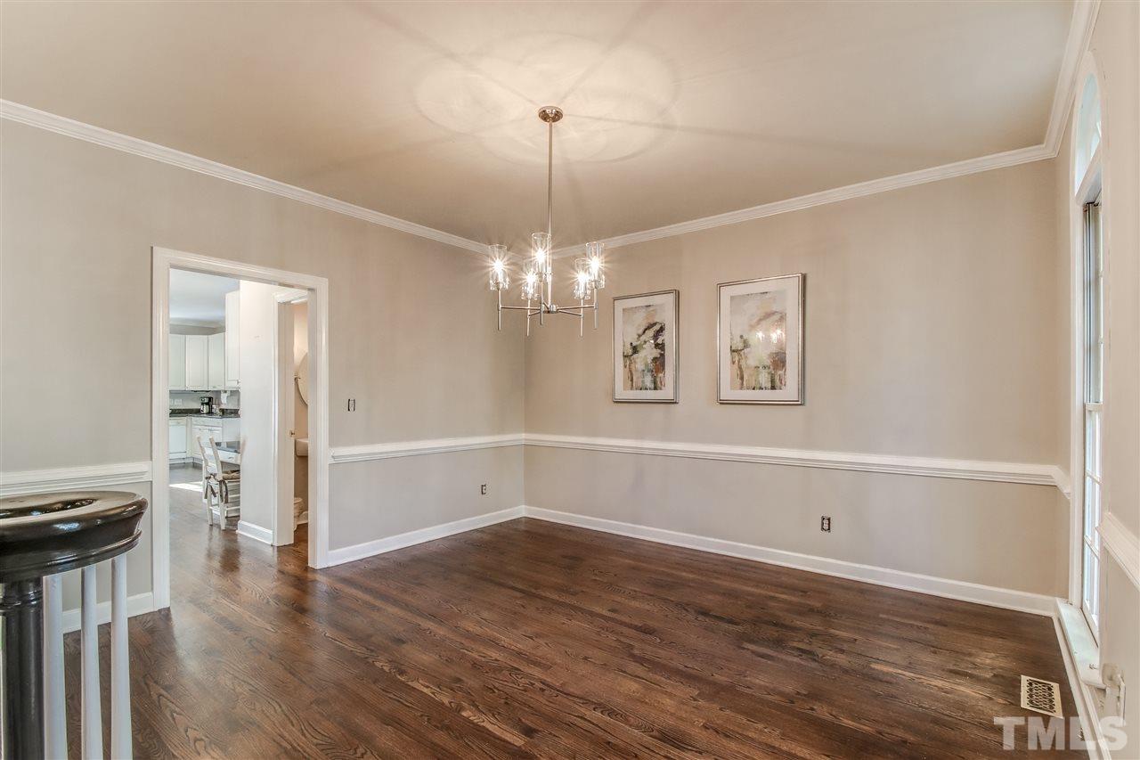 9024 Hemingwood Court Raleigh, NC 27613 - Photo 5 of 28 a view of a room with wooden floor chandelier and windows