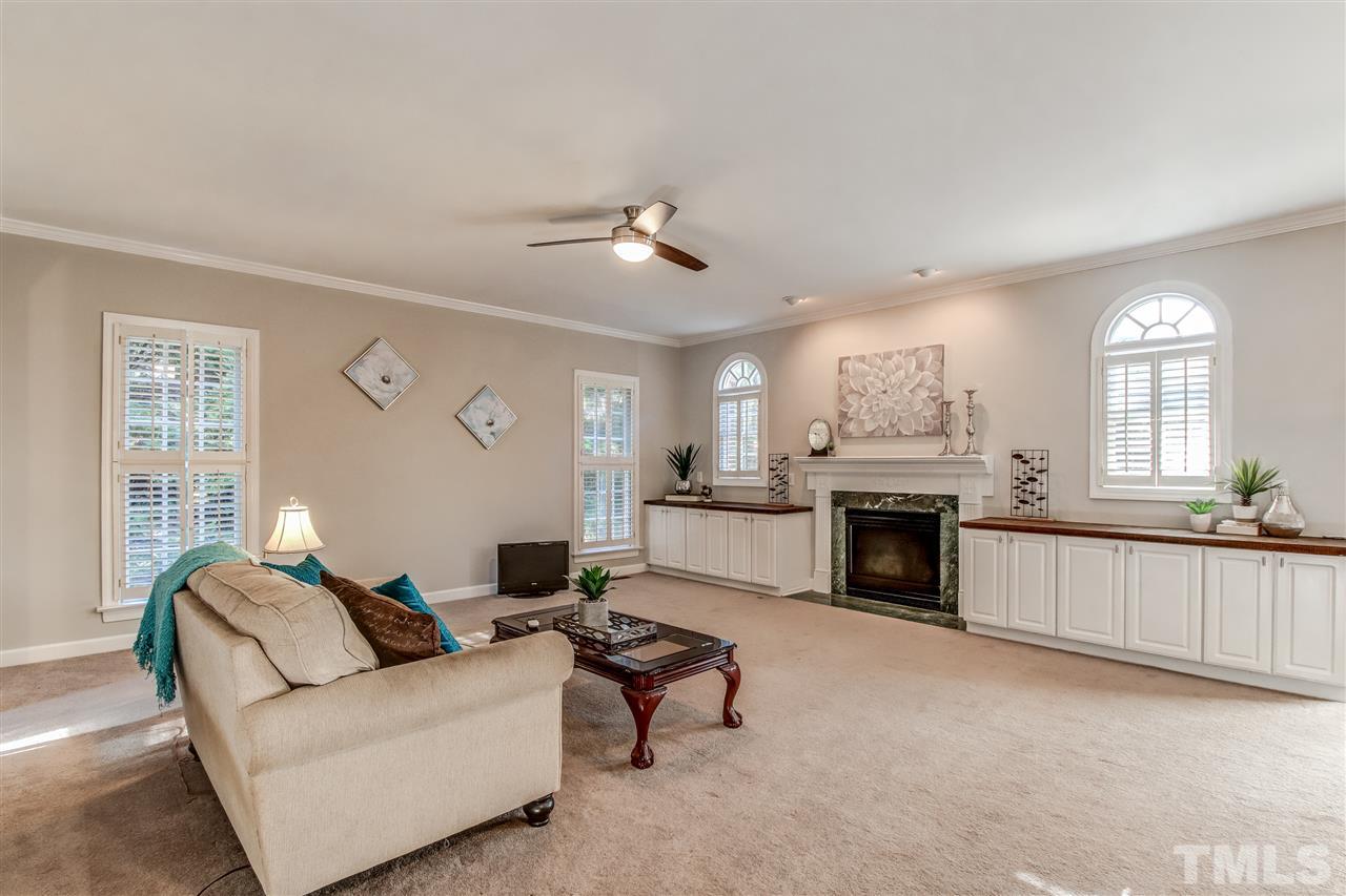 9024 Hemingwood Court Raleigh, NC 27613 - Photo 10 of 28 a living room with furniture and a fireplace