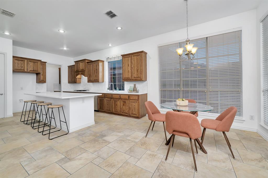 9328 Old Veranda Road Plano, TX 75024 - Photo 12 of 40 a kitchen with stainless steel appliances kitchen island granite countertop a sink and a refrigerator