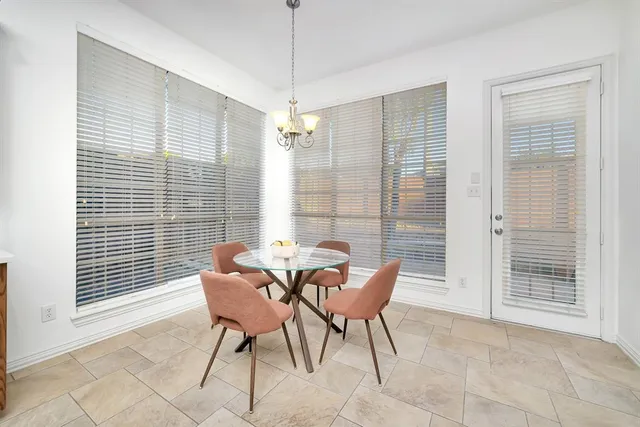 a view of a dining room with furniture and windows