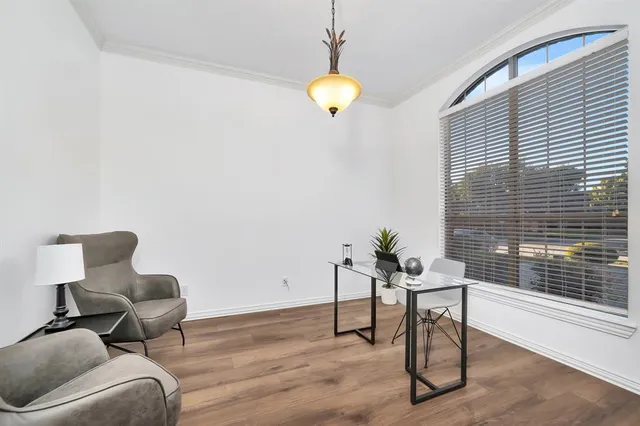 a workspace room with furniture and wooden floor