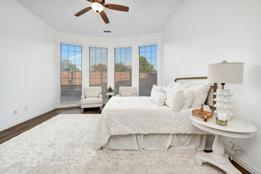 9328 Old Veranda Road Plano, TX 75024 - Photo 22 of 40 a bedroom with a bed and a chandelier