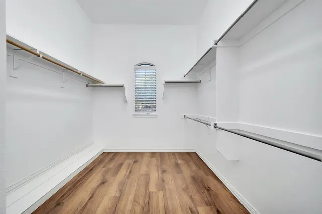a view of a room with wooden floor and white walls