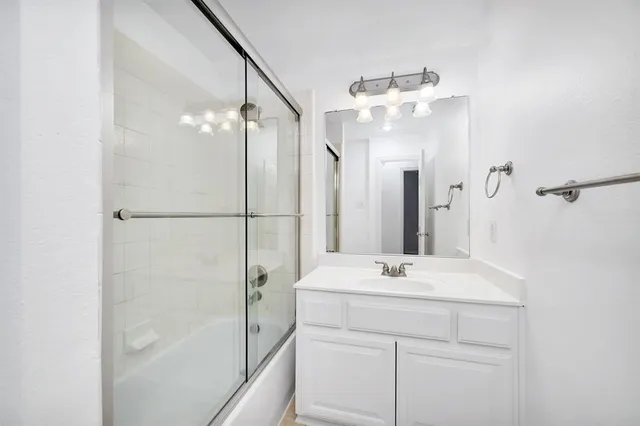 a bathroom with a sink vanity and a mirror