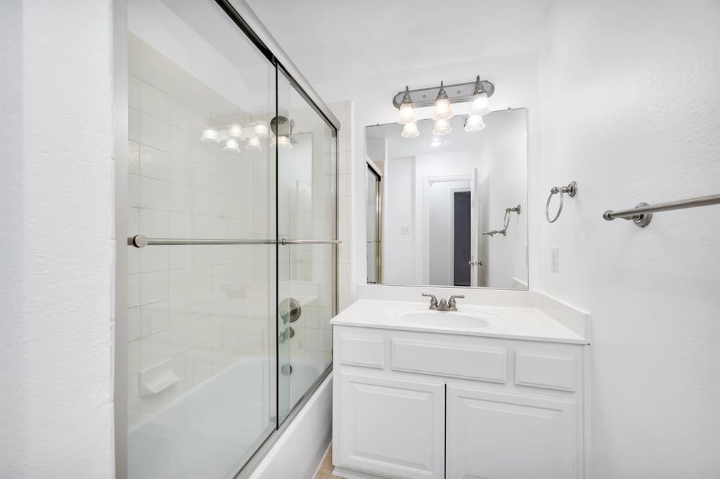 9328 Old Veranda Road Plano, TX 75024 - Photo 34 of 40 a bathroom with a sink vanity and a mirror