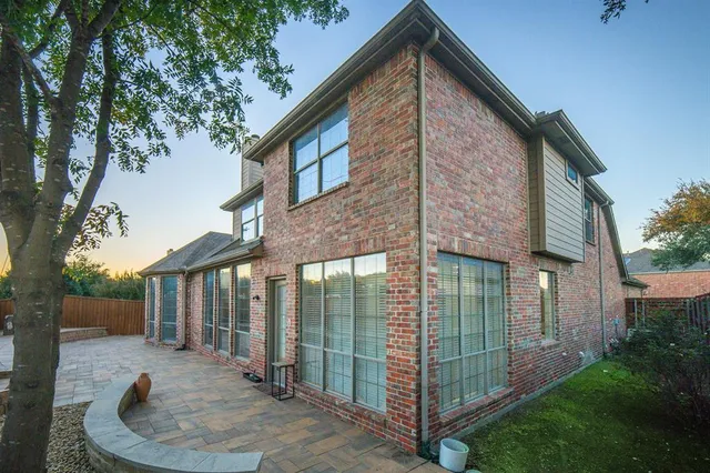 a view of backyard of house with green space