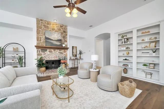 a living room with furniture a fireplace and decor