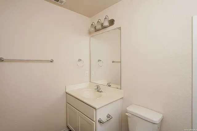 a bathroom with a sink toilet and vanity