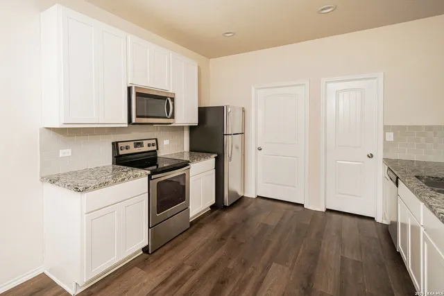a kitchen with a stove a sink and a microwave