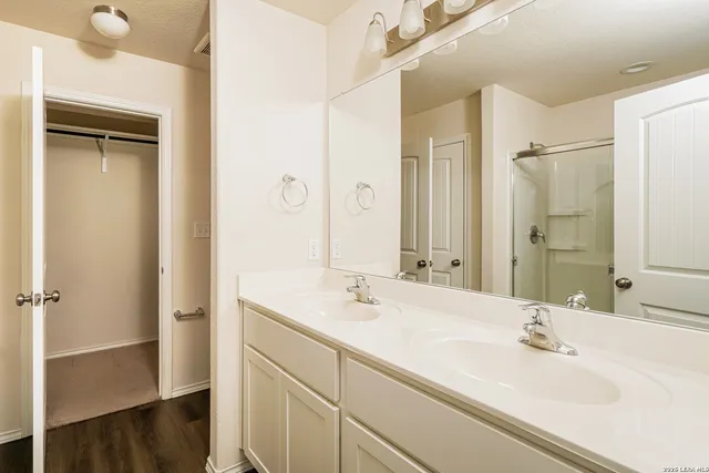 a bathroom with a sink and a large mirror