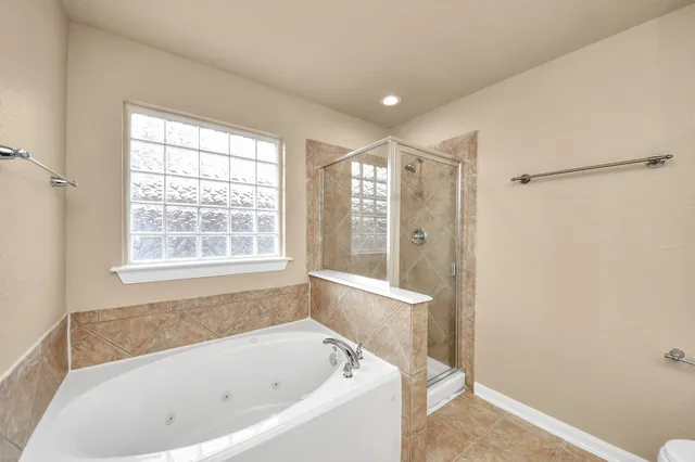a white bath tub sitting next to a window