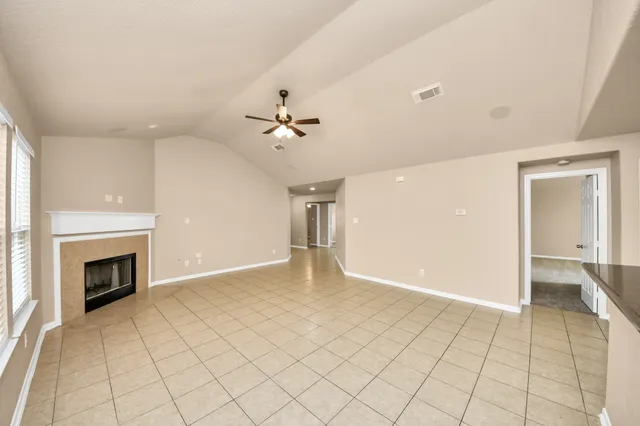 wooden floor in an empty room with a fireplace