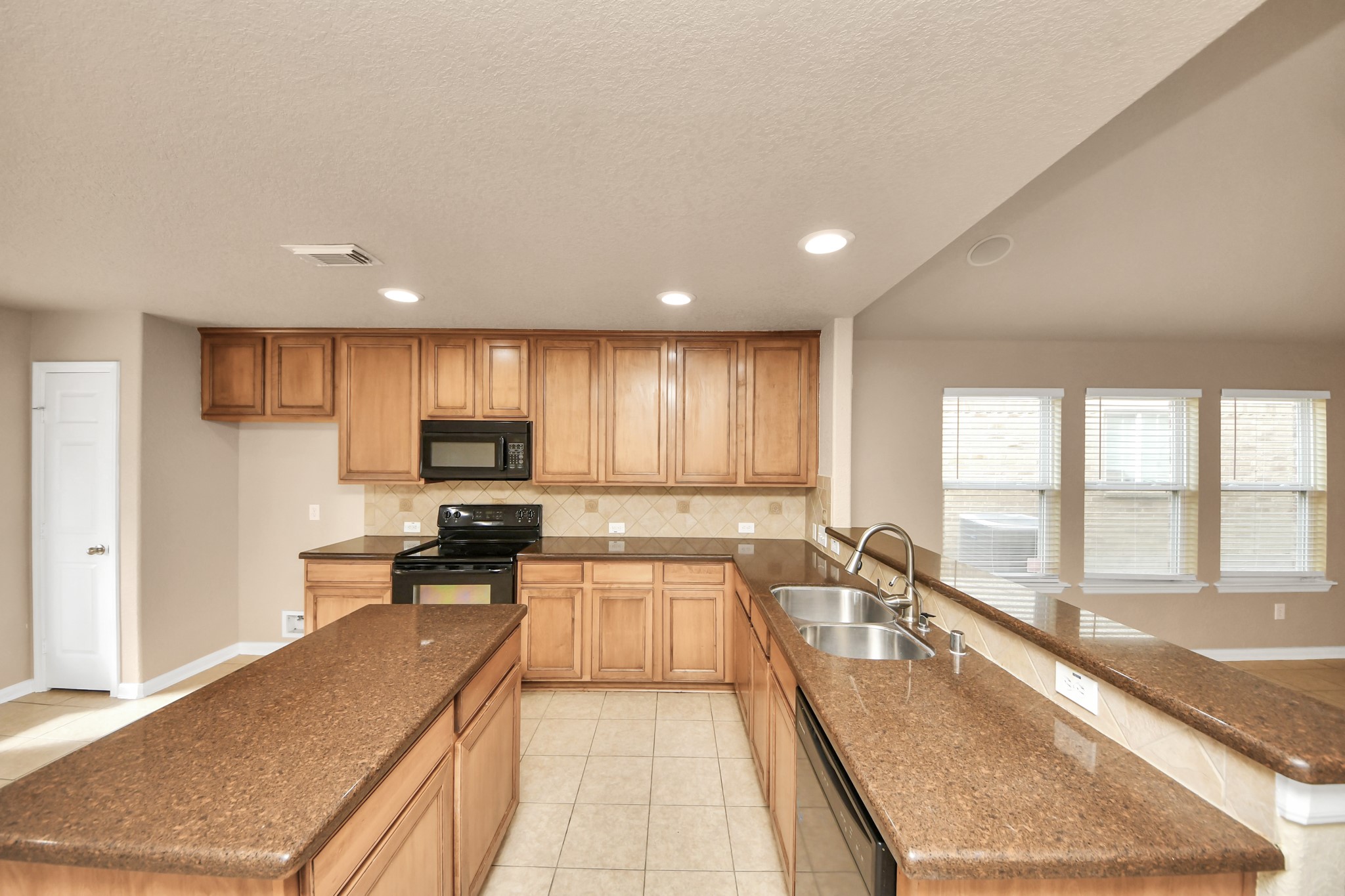 3122 Pathfinders Pass Spring, TX 77373 - Photo 6 of 23 a large kitchen with kitchen island a large window in it