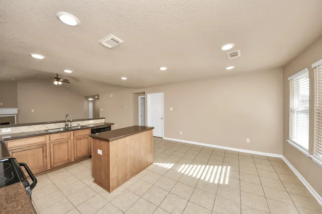 a kitchen with stainless steel appliances granite countertop a sink and cabinets