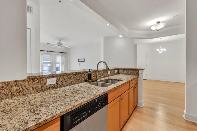 a kitchen with granite countertop a sink and a stove