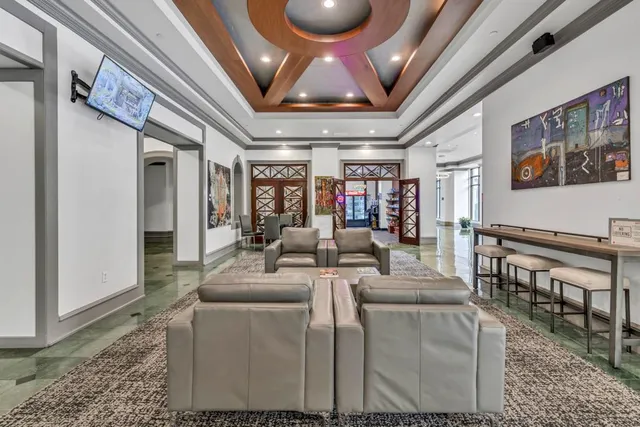 a living room with furniture and a chandelier