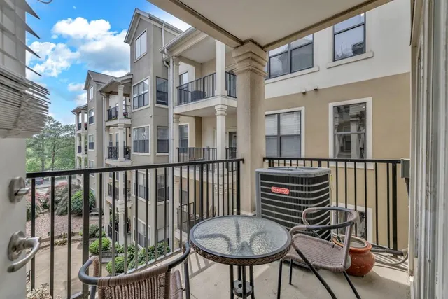 a view of a chair and table in the balcony