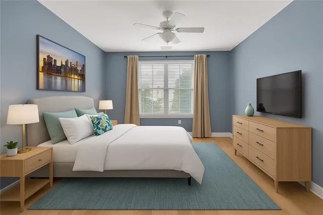 a bedroom with a bed and a flat screen tv in it