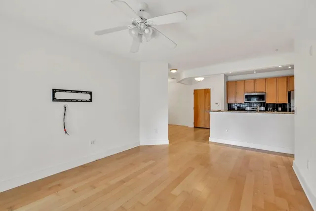 a view of a kitchen with a dishwasher cabinets and wooden floor
