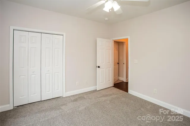 an empty room with a ceiling fan