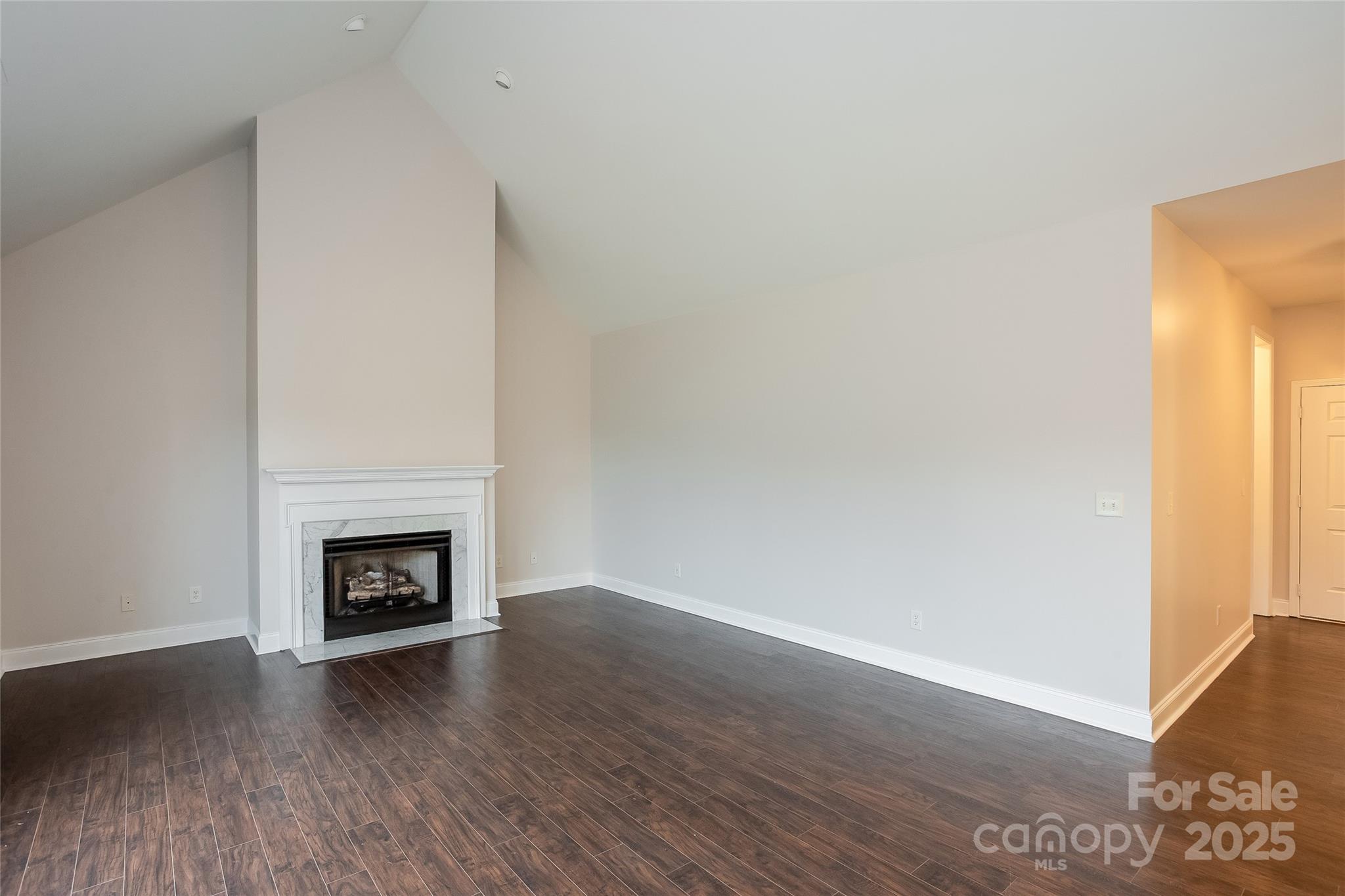 841 Old Farm Road Oakboro, NC 28129 - Photo 4 of 20 a view of a livingroom with wooden floor and a fireplace