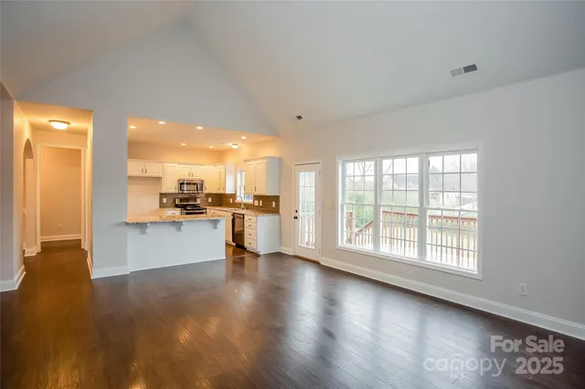 a view of a kitchen with a sink and a large window