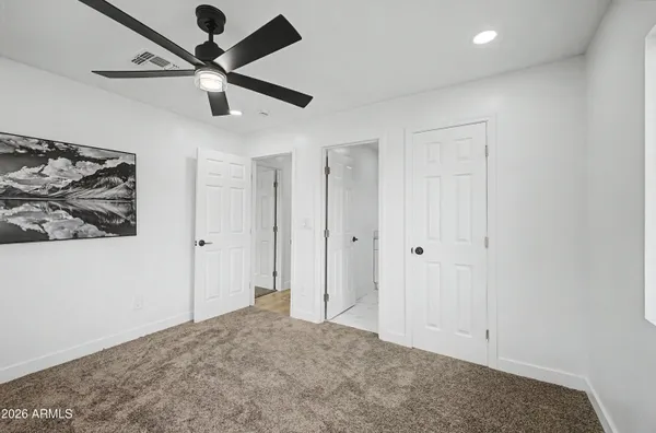a view of a hallway with a ceiling fan