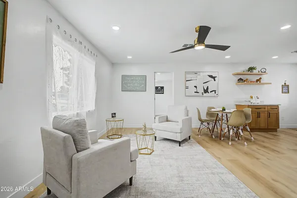 a living room with furniture and wooden floor