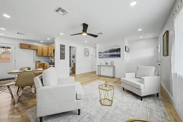 a living room with furniture and kitchen view