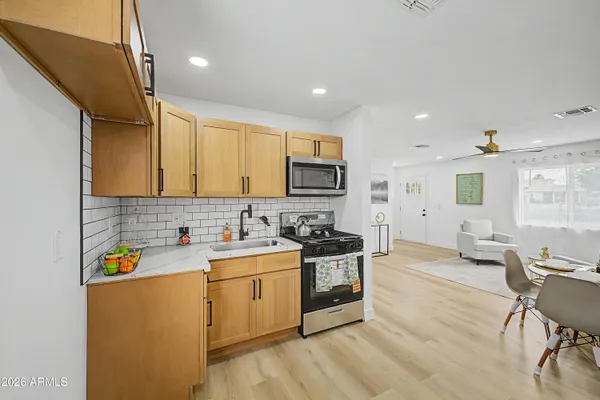 a kitchen with a sink a stove cabinets and counter space