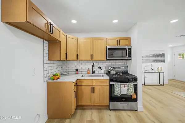 a kitchen that has a sink and a stove top oven