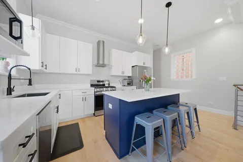 a kitchen with a sink refrigerator and cabinets