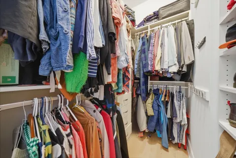 a view of walk in closet with clothes