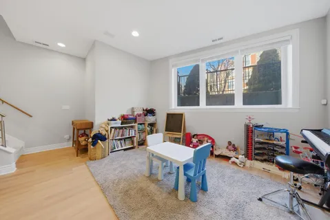 a living room with furniture and a dining table with wooden floor