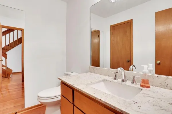 a bathroom with a granite countertop sink toilet and shower