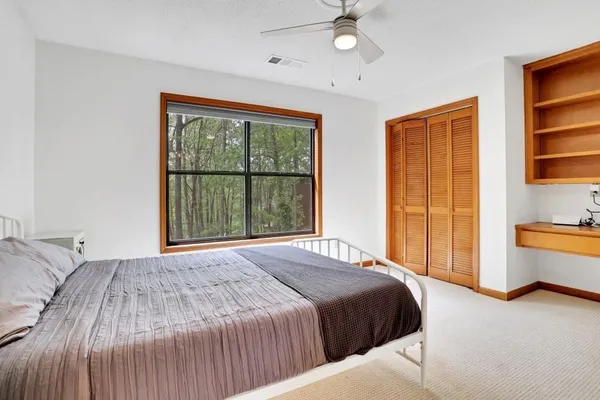 a bedroom with a large bed and a window