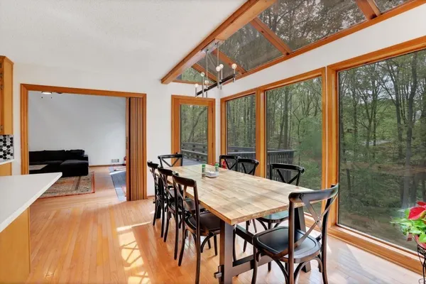 a dining room with furniture a chandelier and wooden floor