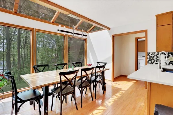 a view of an outdoor dining space with furniture and outside view
