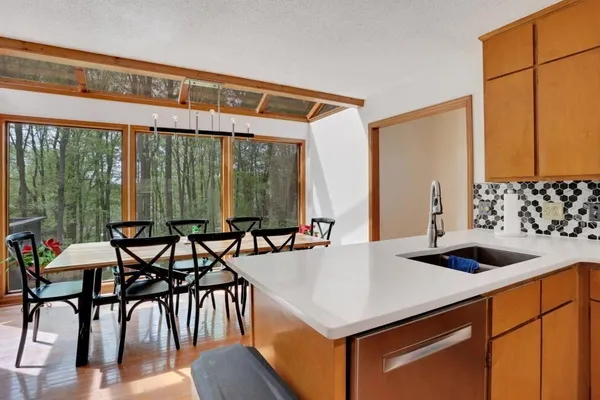 a kitchen that has a table and chairs in it
