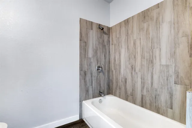 a bathroom with a bathtub and shower