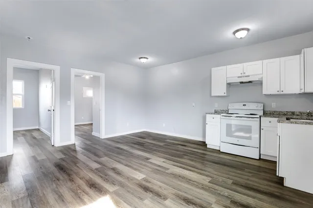a view of kitchen with wooden floor and electronic appliances