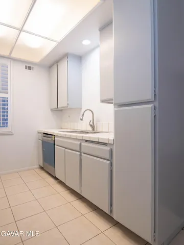 a kitchen with a sink cabinets and window
