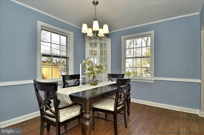 5512 Northfield Road Bethesda, MD 20817 - Photo 2 of 29 a dining room with furniture a chandelier and wooden floor