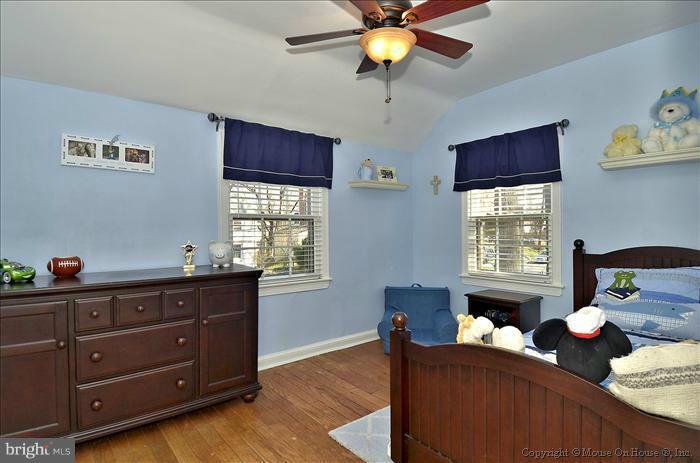 5512 Northfield Road Bethesda, MD 20817 - Photo 11 of 29 a bed room with a bed and a chandelier
