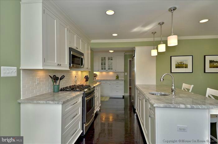 5512 Northfield Road Bethesda, MD 20817 - Photo 18 of 29 a kitchen with granite countertop a sink a stove top oven a counter space and cabinets
