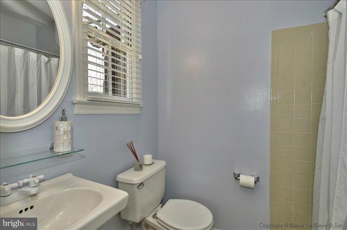 5512 Northfield Road Bethesda, MD 20817 - Photo 19 of 29 a bathroom with a sink a toilet and a mirror
