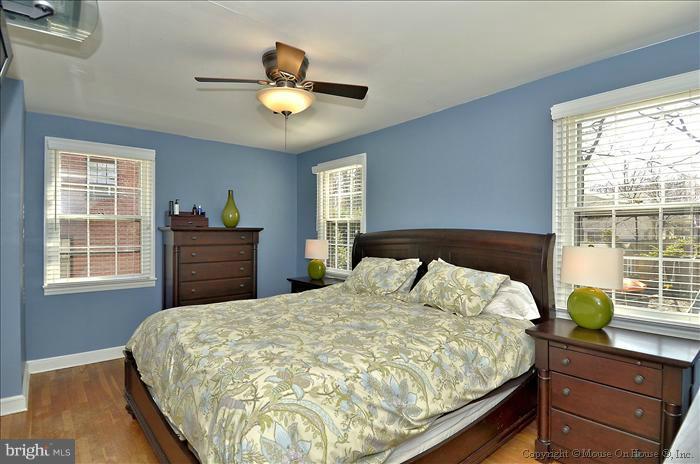 5512 Northfield Road Bethesda, MD 20817 - Photo 23 of 29 a bedroom with a large bed and a chandelier